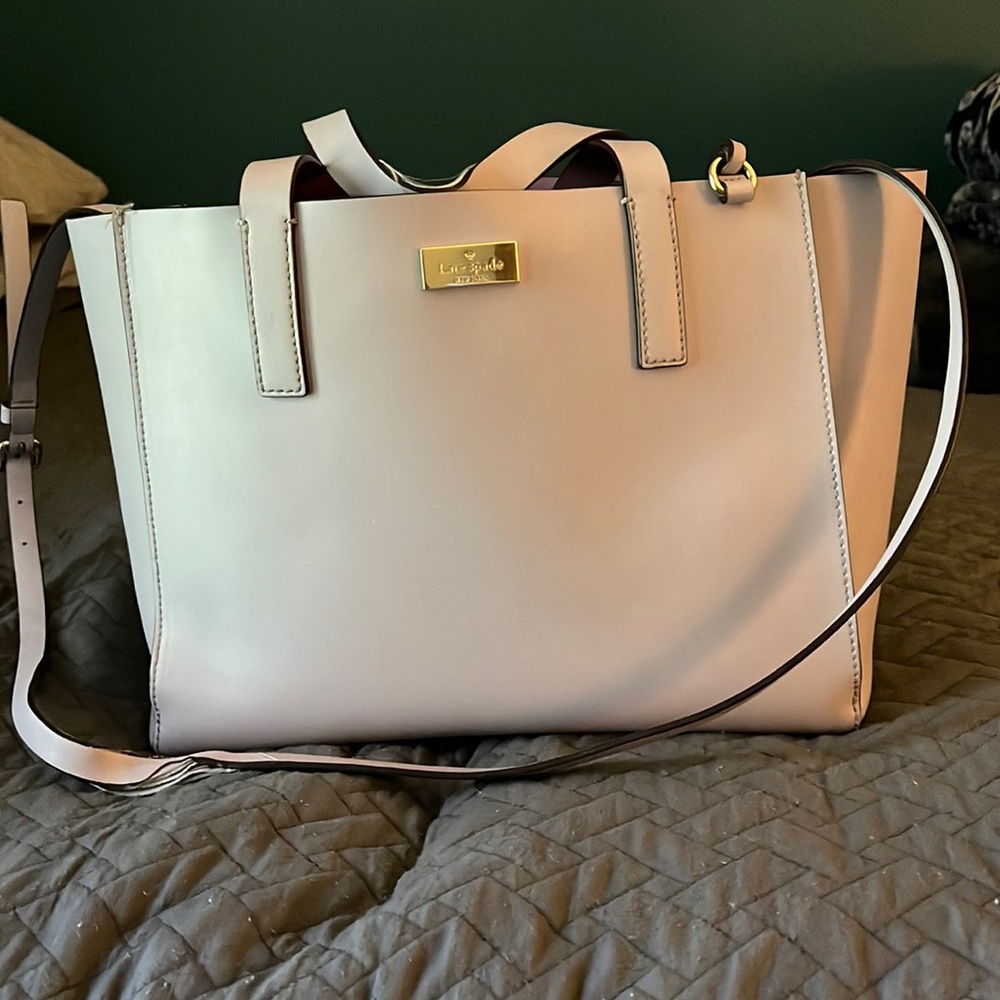 Purple Kate Spade tote bag with shoulder straps, spacious room.